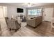 Inviting living room with wood floors, comfortable seating, and lots of natural light at 10233 N Valle Dr, Tampa, FL 33612