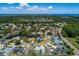 Aerial view of a neighborhood, showing many houses, ponds and trees at 1028 Wyndham Way, Safety Harbor, FL 34695