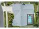 Aerial view of a house showcasing a well-maintained roof, screened-in pool, and lush landscaping at 1028 Wyndham Way, Safety Harbor, FL 34695
