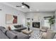 Bright living room featuring a stone fireplace, modern furniture, and ample natural light at 1028 Wyndham Way, Safety Harbor, FL 34695