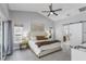 Serene main bedroom with a ceiling fan and sliding door to the ensuite bathroom at 1028 Wyndham Way, Safety Harbor, FL 34695