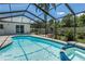 Screened pool area with lush landscaping, spa, and tranquil atmosphere at 1028 Wyndham Way, Safety Harbor, FL 34695
