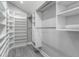 Spacious walk-in closet with custom shelving, offering ample storage solutions at 1028 Wyndham Way, Safety Harbor, FL 34695