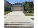 Inviting home featuring a spacious driveway and tidy landscaping at 10607 Ladybug Cv, Parrish, FL 34219