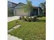 Charming single-story home with a well-manicured lawn and a two-car garage at 10607 Ladybug Cv, Parrish, FL 34219