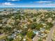 Aerial view of the property showcasing its location near the water and with the city skyline in the distance at 10819 Seminole N Dr, St Petersburg, FL 33708