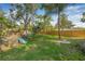 Large backyard featuring a playset, spacious grass area, and a secure wooden fence at 10819 Seminole N Dr, St Petersburg, FL 33708
