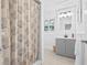 Bright bathroom featuring a vanity, sink, and a shower with a patterned curtain at 10819 Seminole N Dr, St Petersburg, FL 33708