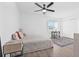 Bright bedroom with hardwood floors featuring bed, desk and a window with lots of light at 10819 Seminole N Dr, St Petersburg, FL 33708