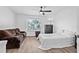 Bright bedroom with a cozy couch and soft bed with dark-wood dresser and decorative bedside lamp at 10819 Seminole N Dr, St Petersburg, FL 33708