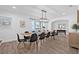 Open dining room with wood floors, seating for ten, and decorative lighting at 10819 Seminole N Dr, St Petersburg, FL 33708