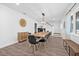 Elegant dining room with hardwood floors, seating for ten and modern light fixture at 10819 Seminole N Dr, St Petersburg, FL 33708