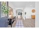 Bright entryway featuring hardwood floors, decorative mirror, and views of the living spaces at 10819 Seminole N Dr, St Petersburg, FL 33708