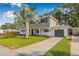 Charming two-story home with attached garage, lush lawn and driveway at 10819 Seminole N Dr, St Petersburg, FL 33708