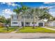 Charming two-story home with lush lawn and two beautiful palm trees at 10819 Seminole N Dr, St Petersburg, FL 33708