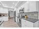 Bright kitchen with stainless steel appliances, grey countertops, and white cabinetry at 10819 Seminole N Dr, St Petersburg, FL 33708