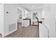 Clean and bright kitchen with white cabinets, hardwood floors, and lots of light at 10819 Seminole N Dr, St Petersburg, FL 33708