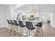 Open kitchen design with white cabinets, gray countertops, and seating for six at 10819 Seminole N Dr, St Petersburg, FL 33708