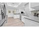 Open kitchen with stainless appliances, gray counters, and stylish tile backsplash at 10819 Seminole N Dr, St Petersburg, FL 33708