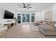 Bright living room with modern fan and sliding glass door access to the backyard at 10819 Seminole N Dr, St Petersburg, FL 33708