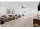 Spacious living room featuring hardwood floors, a ceiling fan, and large windows at 10819 Seminole N Dr, St Petersburg, FL 33708