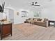 Open-concept living room with hardwood floors, modern lighting, and large windows at 10819 Seminole N Dr, St Petersburg, FL 33708