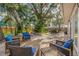 Outdoor patio with stone flooring, a seating area with comfortable blue cushions, and an inviting fire pit at 10819 Seminole N Dr, St Petersburg, FL 33708