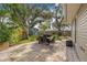 Relaxing patio with dining set and beautiful landscaping creating a serene outdoor space at 10819 Seminole N Dr, St Petersburg, FL 33708