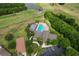 Overhead shot of community clubhouse featuring a sparkling pool, tennis court, and serene surroundings at 1129 Emerald Hill Way, Valrico, FL 33594
