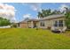 Expansive backyard offers a patio, grill, fire pit, and plenty of room to roam at 1129 Emerald Hill Way, Valrico, FL 33594