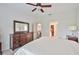 Spacious bedroom boasts dark wood dresser and access to ensuite bathroom and closet at 1129 Emerald Hill Way, Valrico, FL 33594