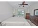 Serene bedroom features large window with backyard view and elegant dark wood furnishings at 1129 Emerald Hill Way, Valrico, FL 33594