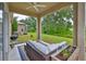 Relaxing covered patio features a ceiling fan, grill, and comfortable seating overlooking the lush backyard at 1129 Emerald Hill Way, Valrico, FL 33594