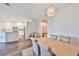 Bright dining area showcases modern light fixture and seamless flow to kitchen at 1129 Emerald Hill Way, Valrico, FL 33594
