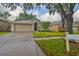 Charming single-Gathering home boasts a well-maintained front yard, two-car garage, and a welcoming entrance at 1129 Emerald Hill Way, Valrico, FL 33594