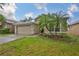 Beautiful home with a well-manicured lawn, lush landscaping, and a two-car garage at 1129 Emerald Hill Way, Valrico, FL 33594