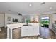 Open-concept kitchen features stainless steel appliances, counter seating, and backyard views at 1129 Emerald Hill Way, Valrico, FL 33594