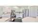 Bright kitchen features stainless steel appliances, white cabinetry, and stylish sink at 1129 Emerald Hill Way, Valrico, FL 33594