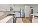 Well-appointed kitchen with stainless steel appliances, tile backsplash and a modern aesthetic at 1129 Emerald Hill Way, Valrico, FL 33594