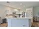 Modern kitchen with stainless steel appliances, white cabinetry and open layout to living area at 1129 Emerald Hill Way, Valrico, FL 33594