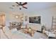 Cozy living room features plush seating, a ceiling fan, and adjacent dining area at 1129 Emerald Hill Way, Valrico, FL 33594
