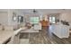Open-concept living room with wood-look floors, lots of natural light, and ceiling fan at 1129 Emerald Hill Way, Valrico, FL 33594
