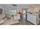 Bright living room boasts wood-look floors, a ceiling fan, and a seamless flow into the kitchen at 1129 Emerald Hill Way, Valrico, FL 33594