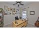 Cozy office space features a ceiling fan, natural light, desk, decorative wall art, and guitar at 1129 Emerald Hill Way, Valrico, FL 33594