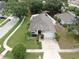 Charming single-story home featuring a manicured front lawn, mature trees, and a driveway leading to an attached garage at 11302 Crane Lake Ct, Riverview, FL 33569