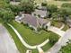An aerial shot reveals the home's spacious yard, lush landscaping, and proximity to community amenities at 11302 Crane Lake Ct, Riverview, FL 33569