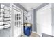 Cozy bathroom featuring a granite countertop vanity, linen closet, and natural light from the patio door at 11302 Crane Lake Ct, Riverview, FL 33569