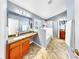 Beautiful bathroom boasts a soaking tub, separate shower, dual vanities, granite countertops, and tile flooring at 11302 Crane Lake Ct, Riverview, FL 33569