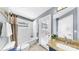 Bright bathroom featuring a shower and tub combination, granite countertops, and access to the outdoors at 11302 Crane Lake Ct, Riverview, FL 33569