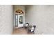 Front porch seating area, with door and hanging light fixture at 11302 Crane Lake Ct, Riverview, FL 33569